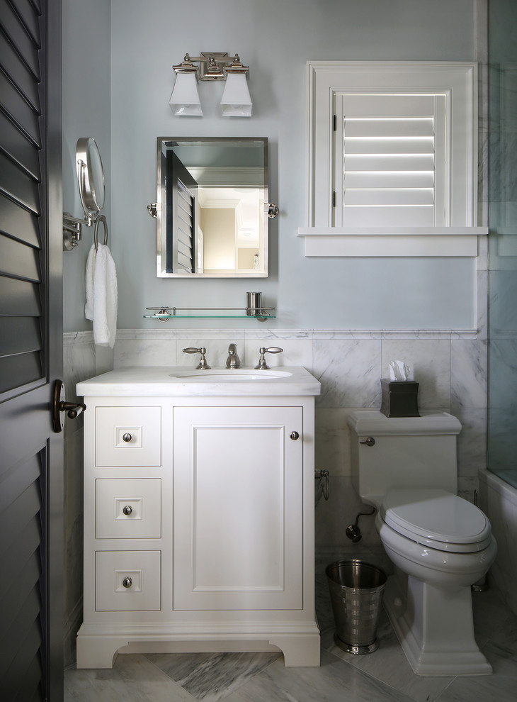 Design ideas for a tropical bathroom in Tampa with an undermount sink, an alcove tub and a one-piece toilet.