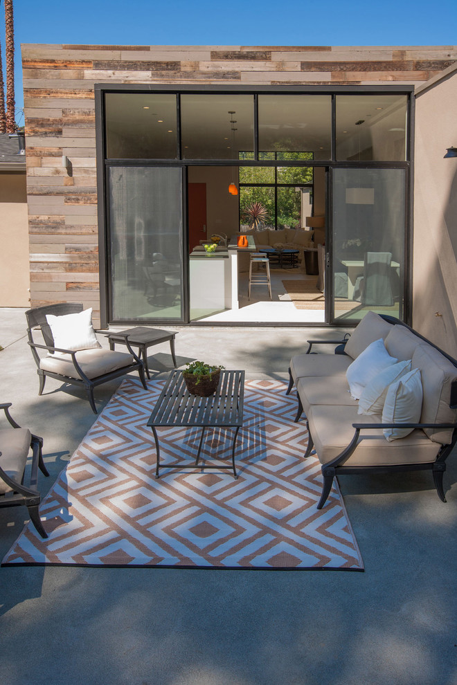 This is an example of a small contemporary backyard patio in San Francisco with concrete slab and no cover.