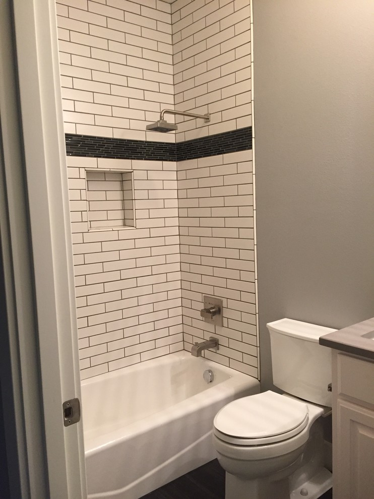 Inspiration for a large contemporary master bathroom in Portland with raised-panel cabinets, white cabinets, an alcove tub, a shower/bathtub combo, a two-piece toilet, white tile, subway tile, grey walls, dark hardwood floors, an undermount sink, brown floor and an open shower.
