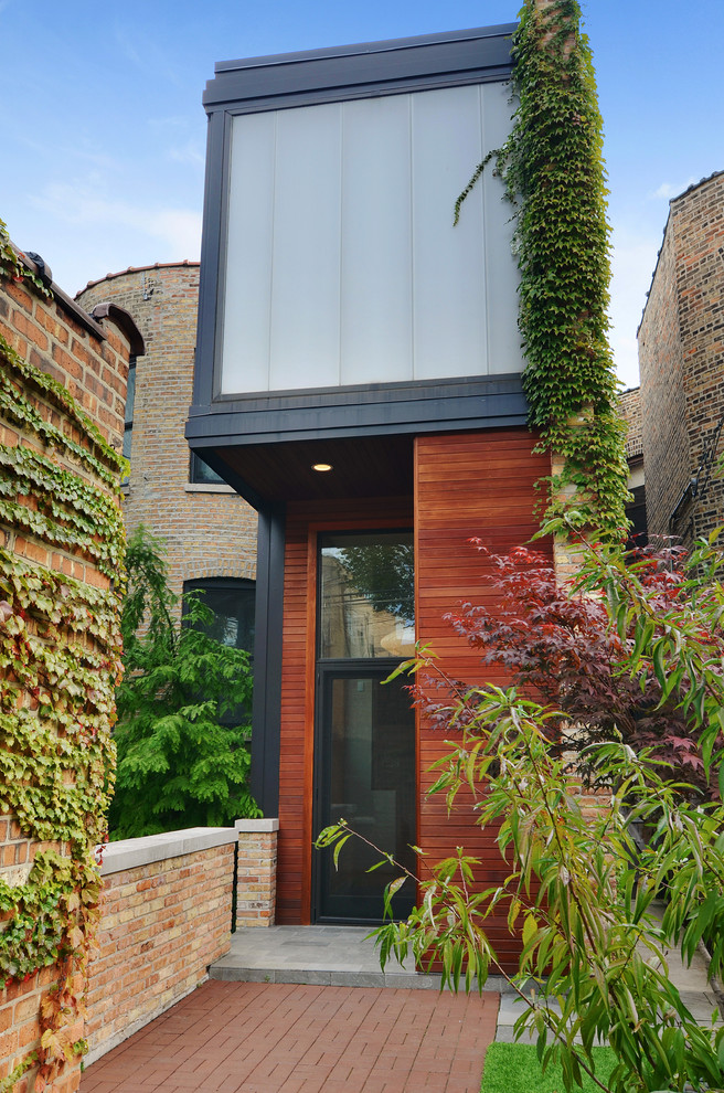 Photo of a contemporary two-storey brick red exterior in Chicago.