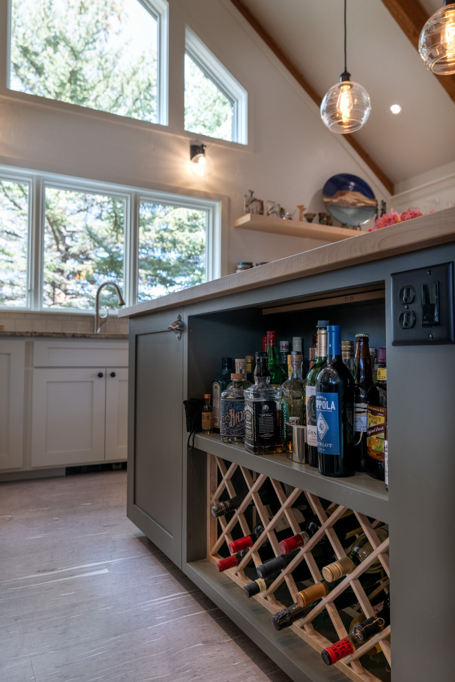 Example of a mid-sized transitional u-shaped vaulted ceiling eat-in kitchen design with shaker cabinets, green cabinets, granite countertops, beige backsplash, ceramic backsplash, stainless steel appliances, an island and multicolored countertops
