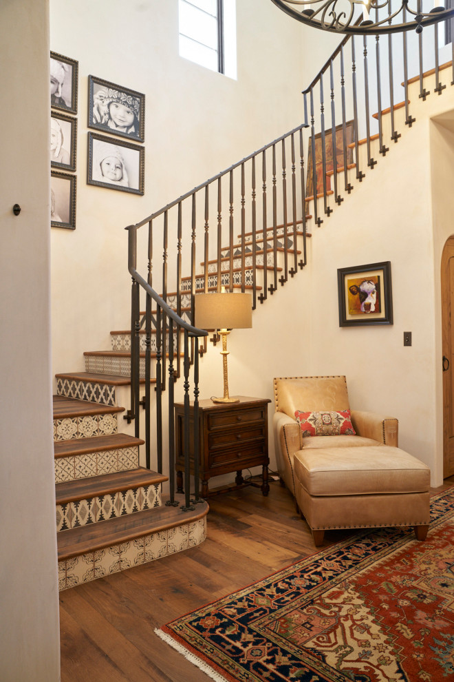 Wood u-shaped staircase in Wichita with tile risers and metal railing.