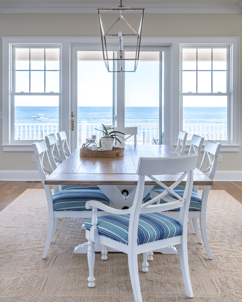 Design ideas for a large beach style open plan dining in New York with beige walls, medium hardwood floors, brown floor and no fireplace.