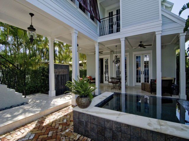 Inspiration for a small traditional backyard rectangular pool in Miami with brick pavers.