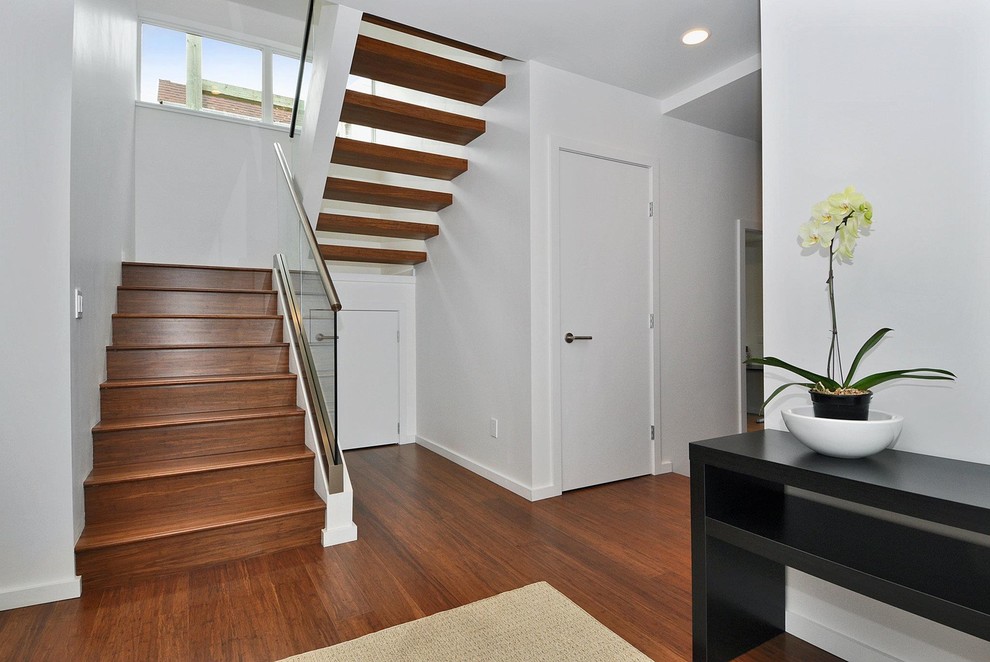 Inspiration for a mid-sized modern wood u-shaped staircase in Seattle with wood risers.