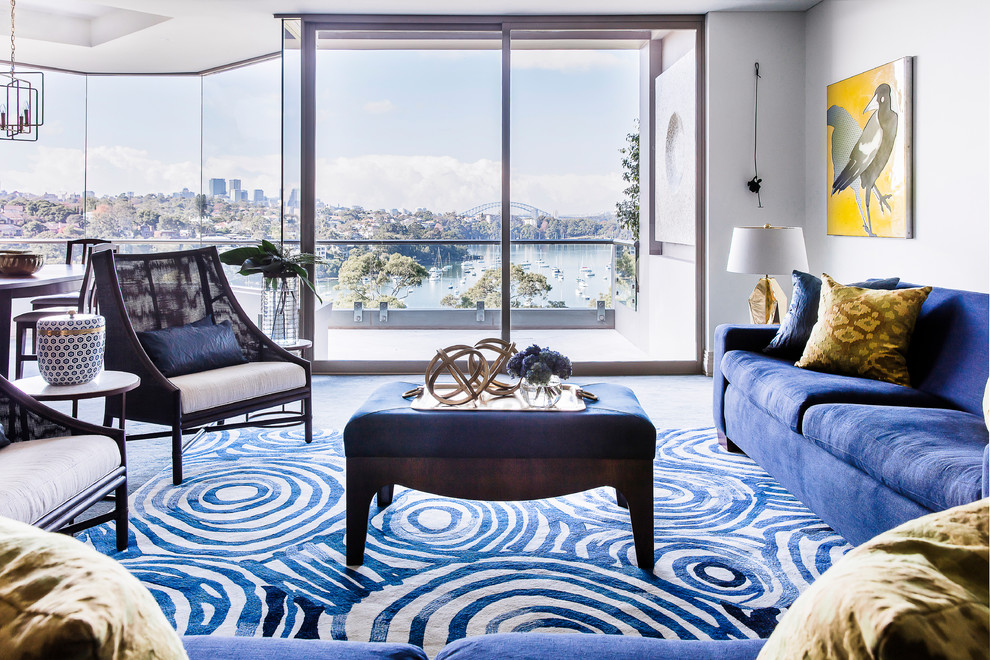 This is an example of a large transitional formal open concept living room in Sydney with blue walls, carpet, no fireplace, no tv and blue floor.