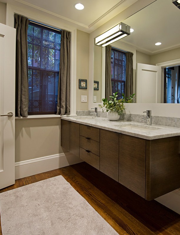 Inspiration for a contemporary bathroom in Boston with an undermount sink, medium wood cabinets and marble benchtops.
