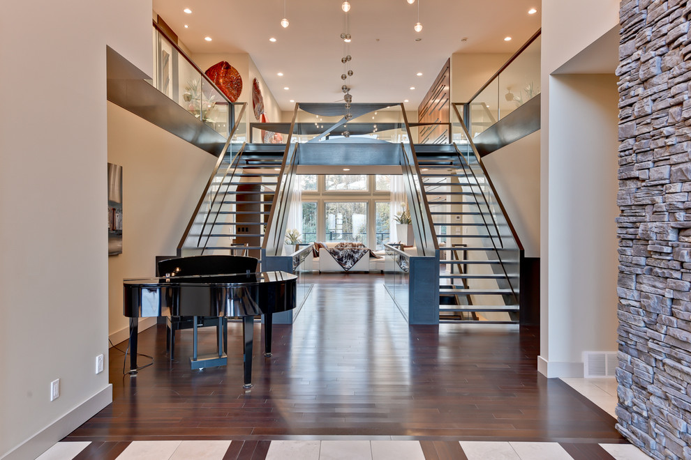Expansive contemporary u-shaped staircase in Calgary with open risers and metal railing.