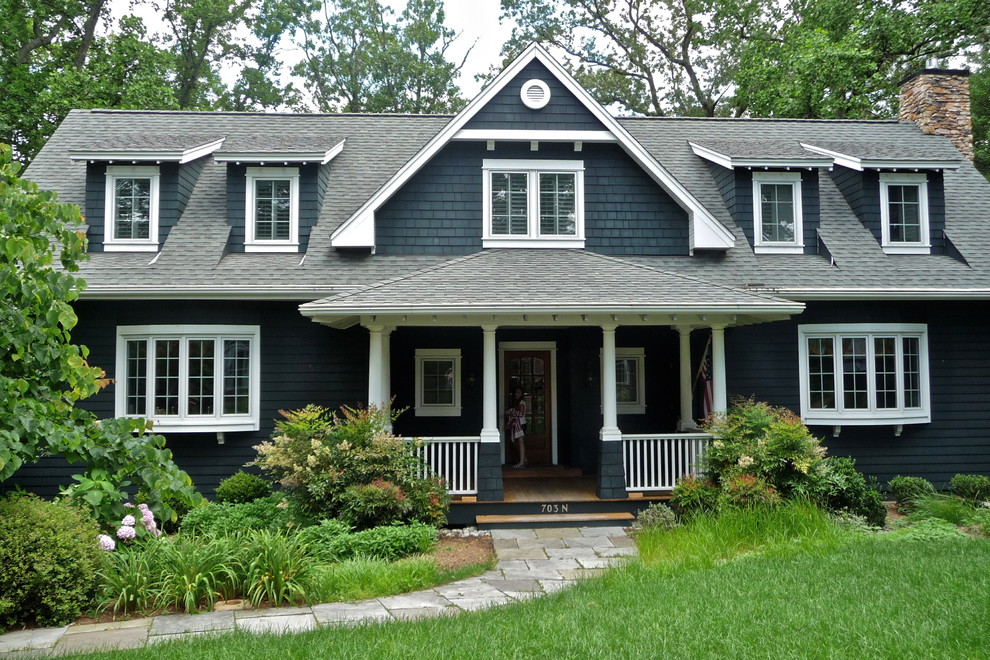 Photo of a mid-sized traditional three-storey green exterior in Baltimore with wood siding and a gable roof.