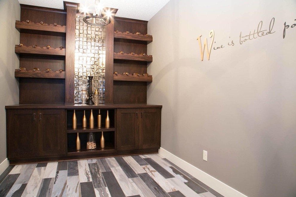 Inspiration for a large transitional wine cellar in Minneapolis with porcelain floors and display racks.