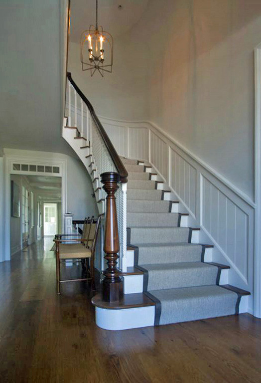 Medium sized traditional staircase in Boston with wainscoting.