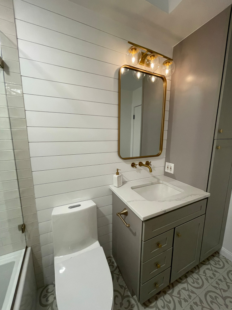 This is an example of a small traditional master bathroom in DC Metro with recessed-panel cabinets, grey cabinets, a one-piece toilet, white tile, white walls, ceramic floors, a drop-in sink, granite benchtops, multi-coloured floor, white benchtops, a niche, a single vanity and a freestanding vanity.