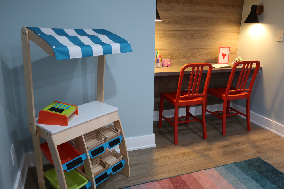 Mid-sized eclectic gender-neutral light wood floor and brown floor kids' room photo in Philadelphia with blue walls