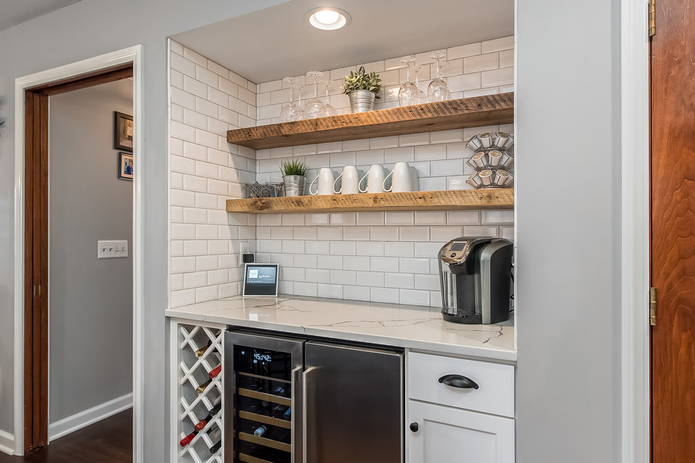 Example of a large transitional u-shaped eat-in kitchen design in Columbus with shaker cabinets, quartz countertops, white backsplash and an island