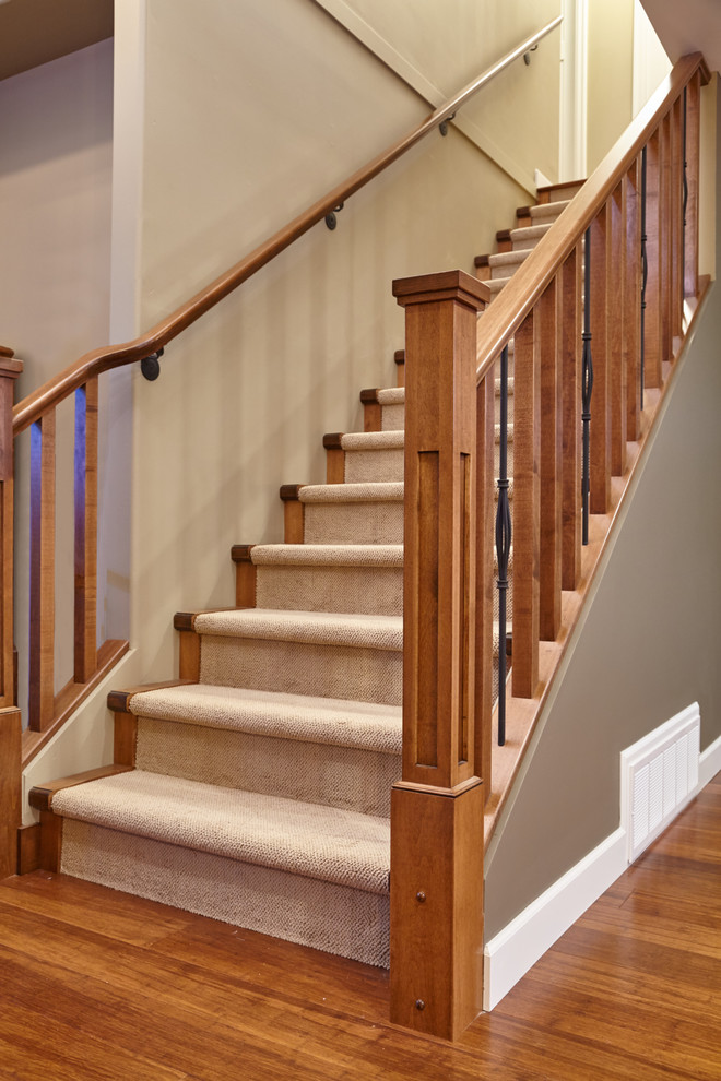 Photo of a small transitional carpeted straight staircase in Vancouver with wood risers.