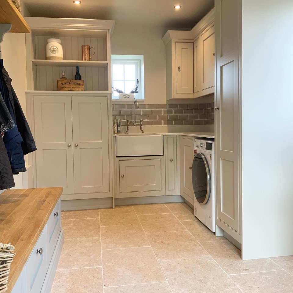 Photo of a large utility room in Buckinghamshire with a belfast sink, shaker cabinets, quartz worktops, grey splashback, ceramic splashback and white worktops.
