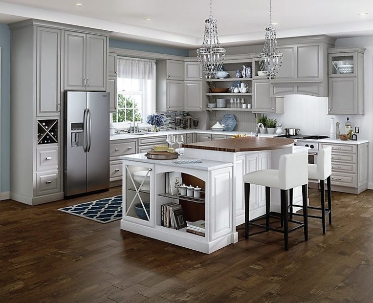 Inspiration for a large transitional l-shaped dark wood floor eat-in kitchen remodel with an undermount sink, raised-panel cabinets, gray cabinets, quartzite countertops, white backsplash, stainless steel appliances and an island
