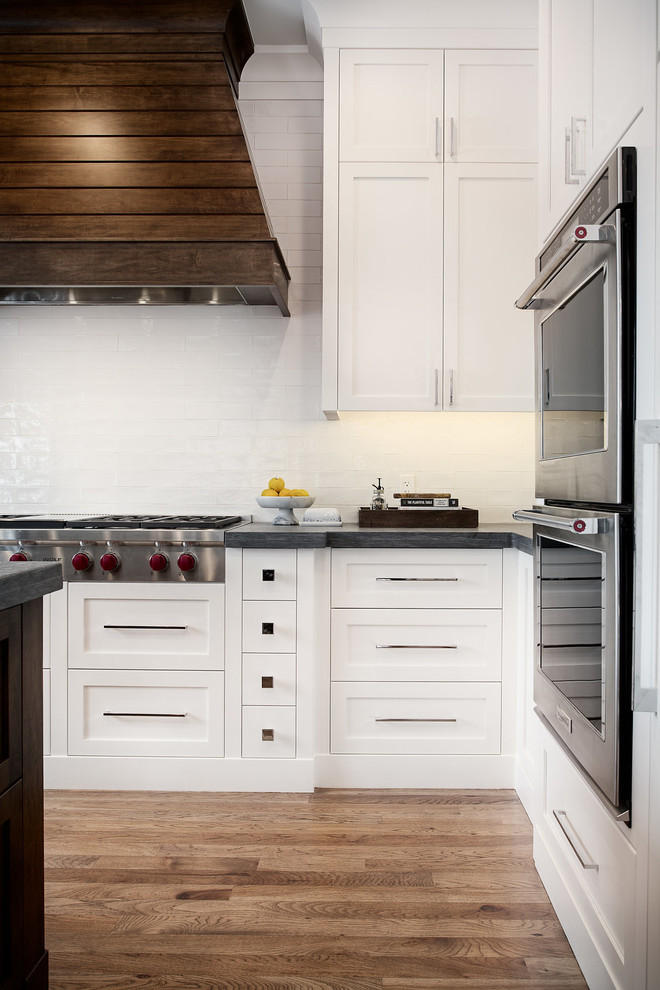 Large transitional u-shaped eat-in kitchen photo in Calgary with shaker cabinets, paneled appliances and an island