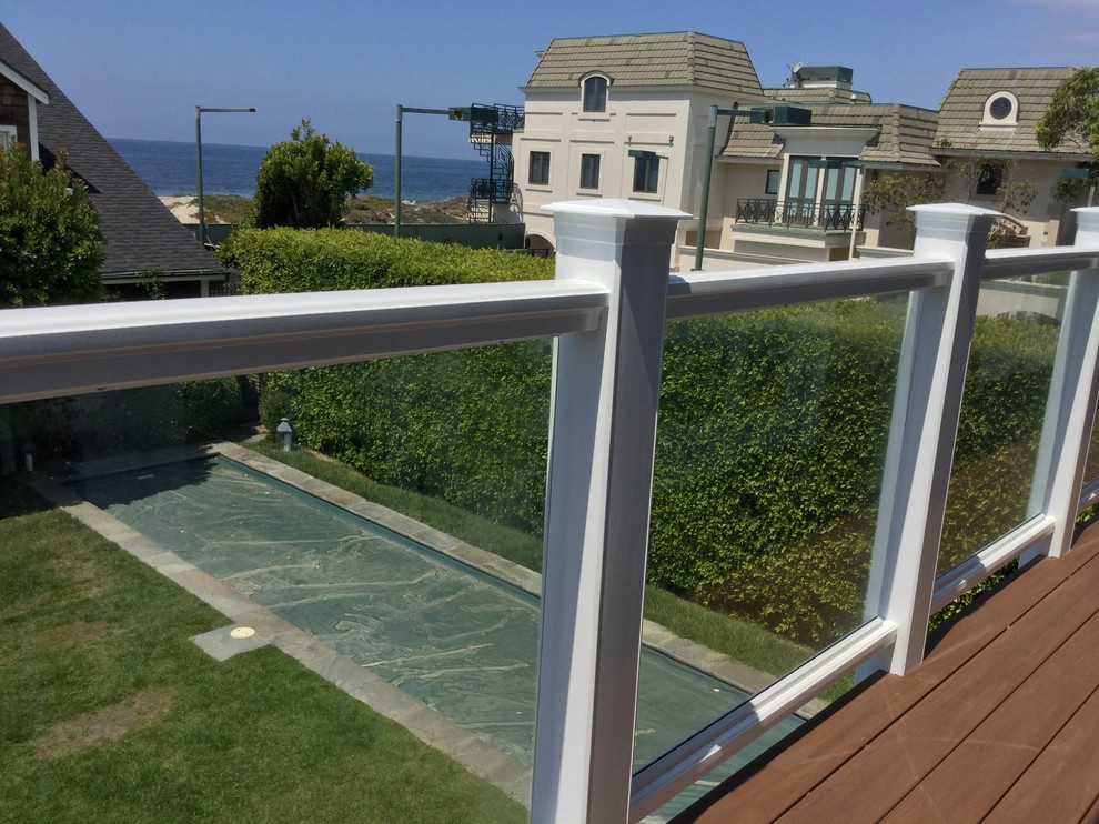 Photo of a large beach style backyard deck in Los Angeles with a pergola.