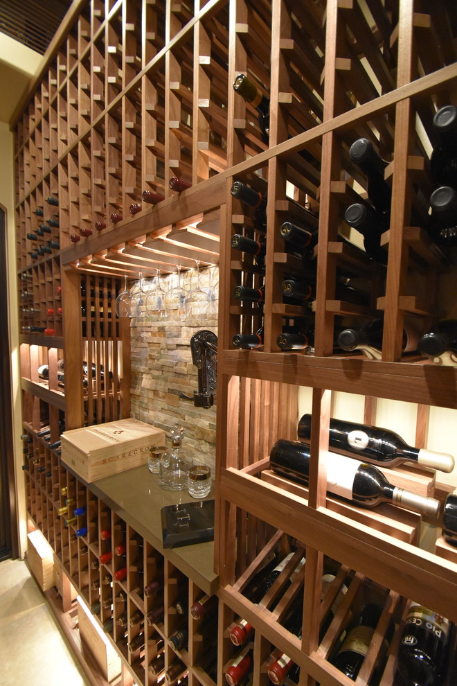 Photo of a mid-sized traditional wine cellar in Los Angeles with terra-cotta floors and display racks.
