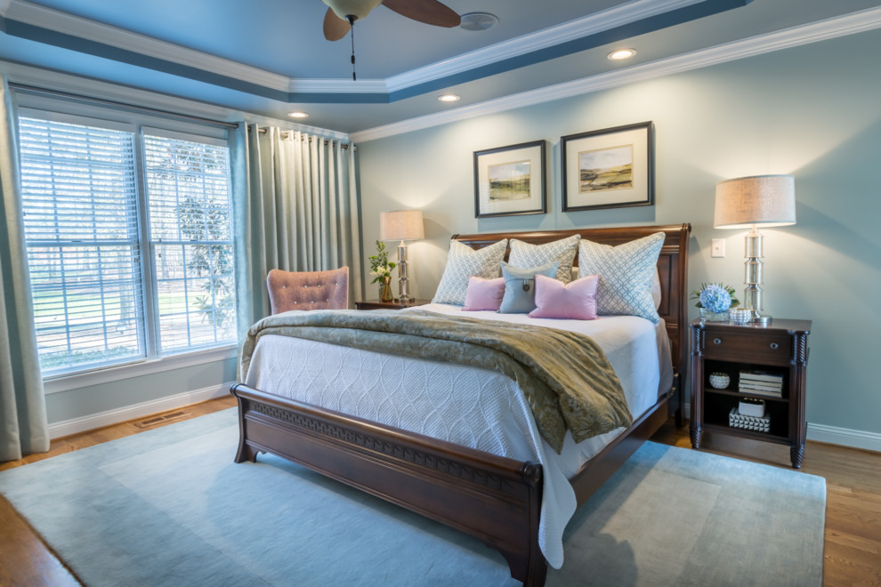 Design ideas for a mid-sized transitional master bedroom in Raleigh with grey walls, medium hardwood floors, no fireplace and brown floor.