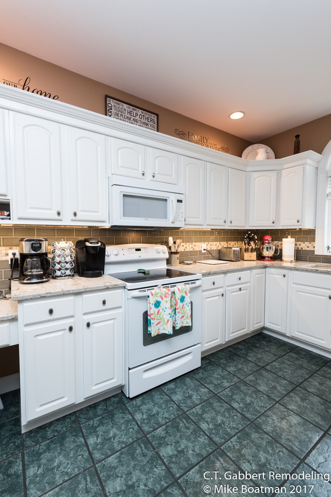 Inspiration for a mid-sized transitional l-shaped kitchen remodel in Chicago with a double-bowl sink, beaded inset cabinets, white cabinets, quartz countertops, beige backsplash, subway tile backsplash, stainless steel appliances and an island