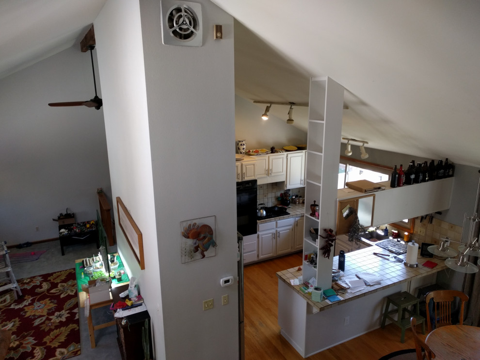 Kitchen - mid-sized transitional u-shaped medium tone wood floor and multicolored floor kitchen idea in Denver with a farmhouse sink, shaker cabinets, brown cabinets, granite countertops, beige backsplash, subway tile backsplash, stainless steel appliances, an island and multicolored countertops