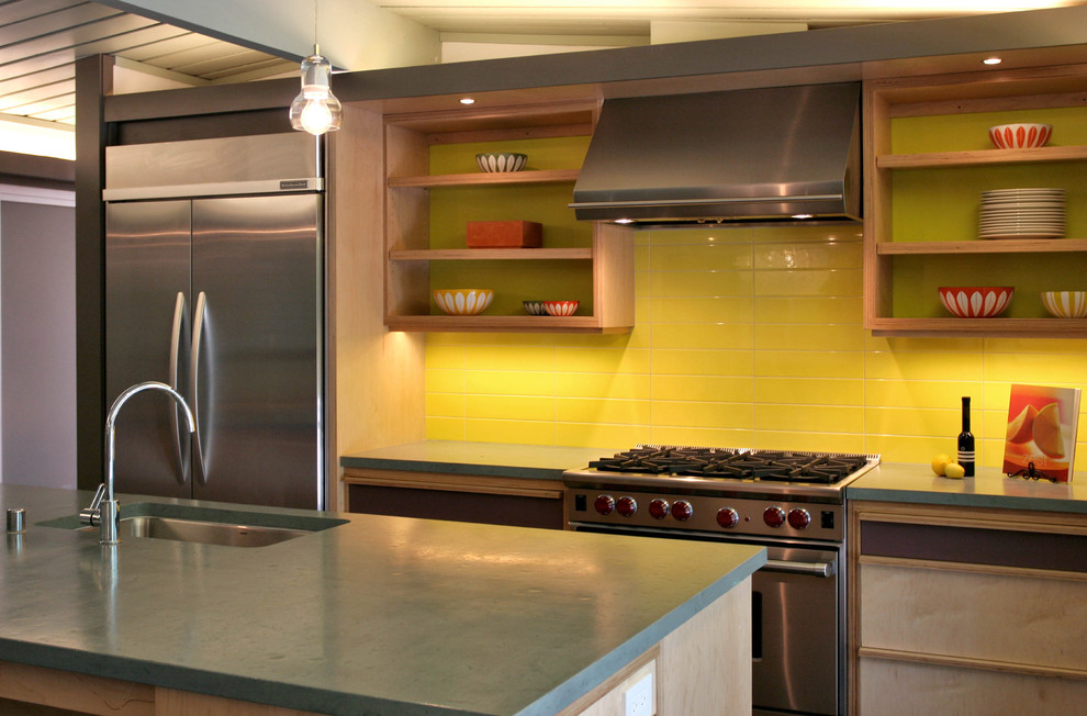 Design ideas for a midcentury eat-in kitchen in San Francisco with an undermount sink, recessed-panel cabinets, light wood cabinets, concrete benchtops, yellow splashback, ceramic splashback, stainless steel appliances, ceramic floors and with island.