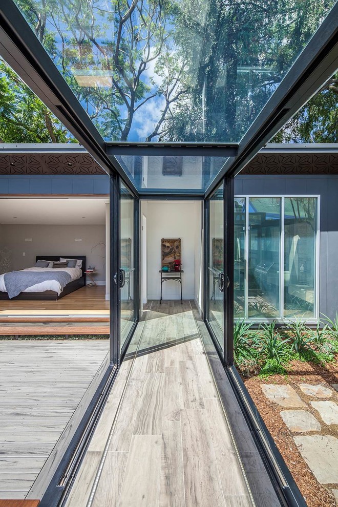 Photo of a mid-sized modern hallway in Sydney with grey floor and travertine floors.