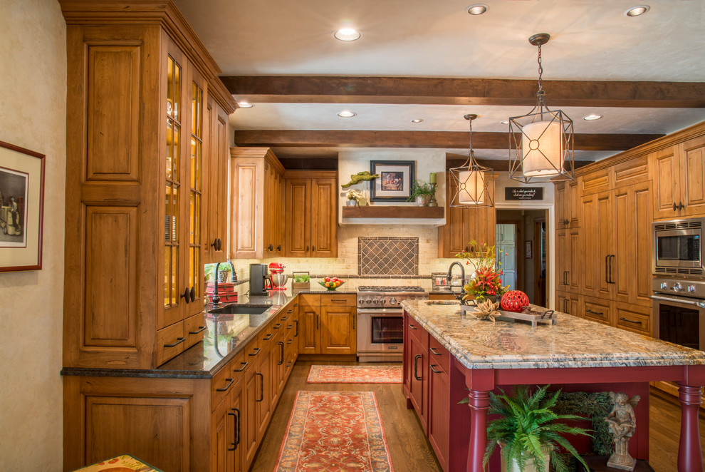 Inspiration for an expansive traditional kitchen in Wichita with an undermount sink, raised-panel cabinets, medium wood cabinets, granite benchtops, subway tile splashback, stainless steel appliances, medium hardwood floors and with island.