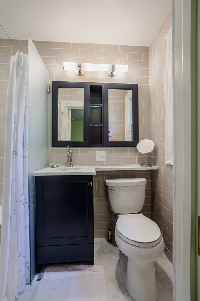 Small traditional 3/4 bathroom in New York with recessed-panel cabinets, marble benchtops, a two-piece toilet, green tile, ceramic tile, mosaic tile floors and black cabinets.