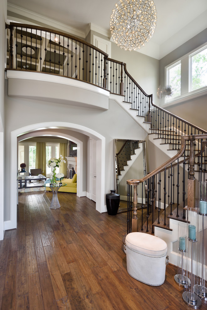 Design ideas for a transitional foyer in Houston with grey walls and dark hardwood floors.