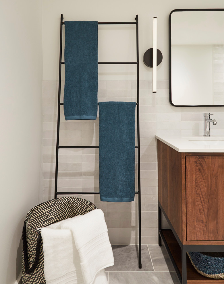 Photo of a mid-sized contemporary master bathroom in Chicago with flat-panel cabinets, medium wood cabinets, a freestanding tub, a corner shower, a two-piece toilet, white tile, ceramic tile, white walls, marble floors, an undermount sink, engineered quartz benchtops, white floor, a hinged shower door, white benchtops, a niche, a double vanity and a freestanding vanity.