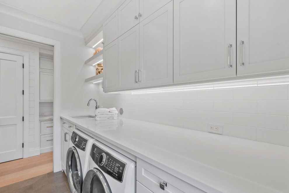 Large transitional laundry room in Other with beaded inset cabinets, white cabinets, quartzite benchtops and white benchtop.