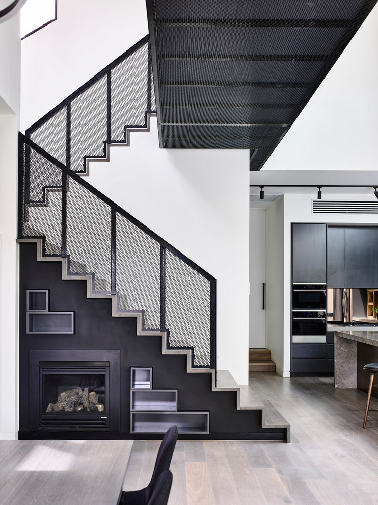 Large contemporary wood u-shaped staircase in Melbourne with wood risers.