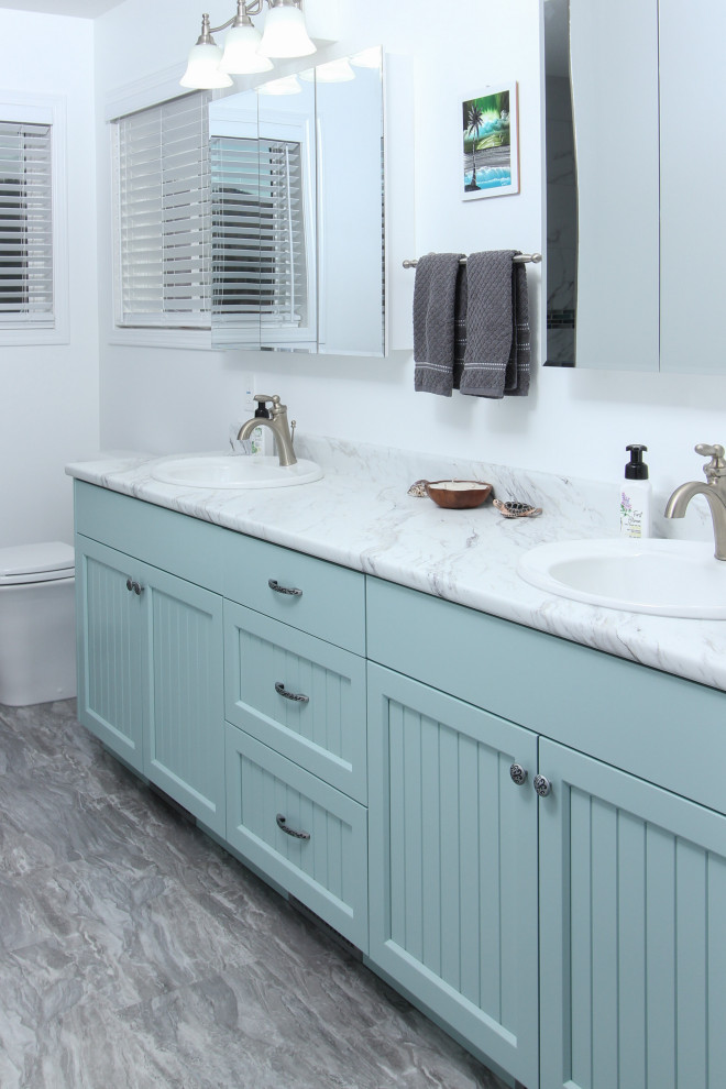 Design ideas for a traditional bathroom in Vancouver with shaker cabinets, turquoise cabinets, a drop-in sink, laminate benchtops and white benchtops.