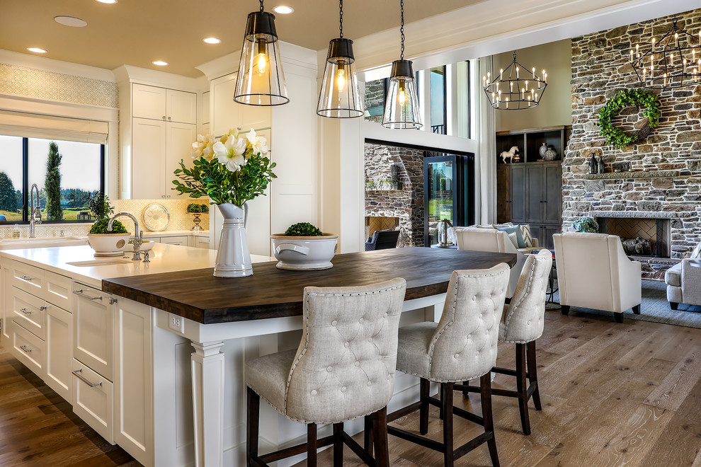 Inspiration for an expansive country open plan kitchen in Portland with a farmhouse sink, shaker cabinets, white cabinets, quartz benchtops, green splashback, ceramic splashback, panelled appliances, medium hardwood floors, with island, beige floor and yellow benchtop.