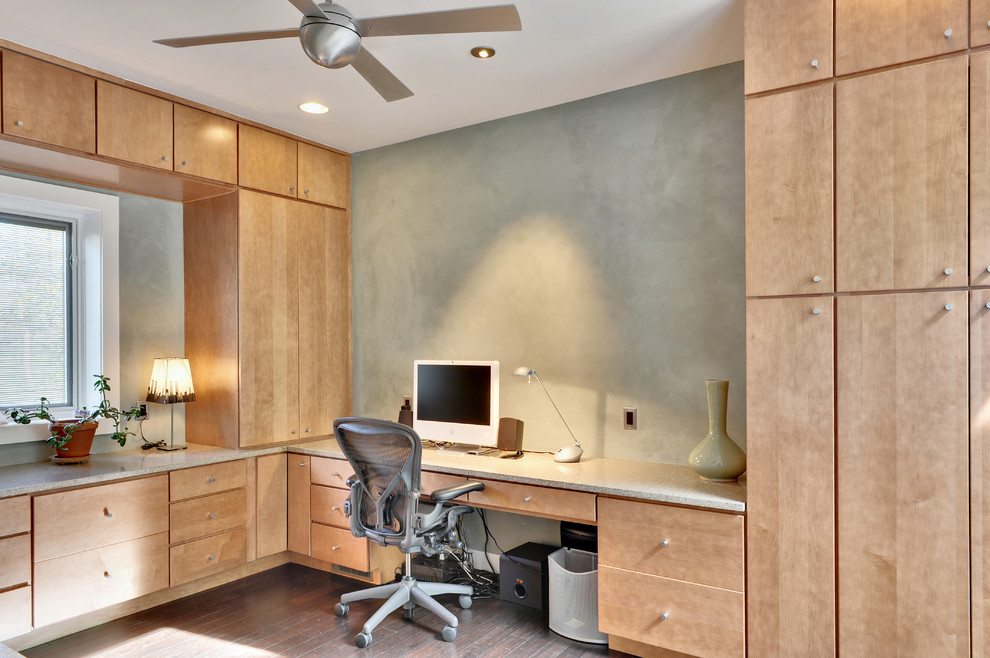 Inspiration for a contemporary home office in Other with dark hardwood floors and a built-in desk.