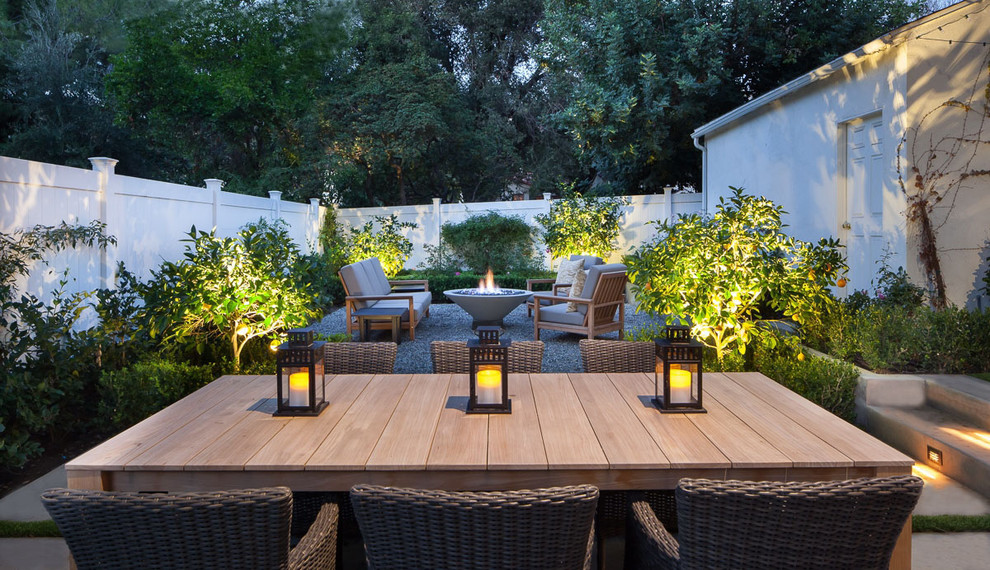 Photo of a mid-sized traditional backyard patio in Los Angeles with a fire feature, gravel and no cover.