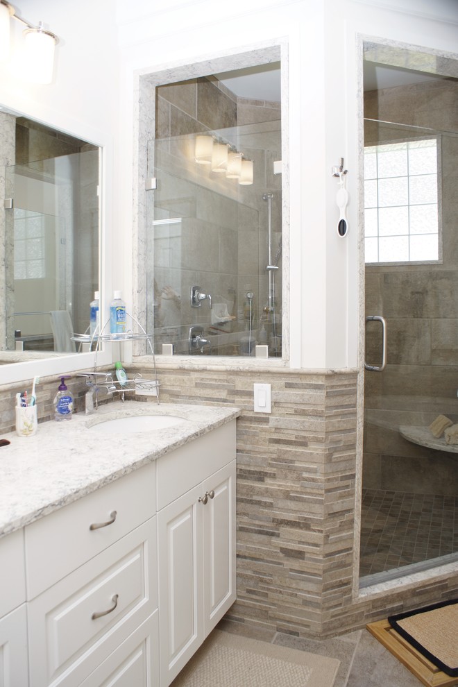Drop-in bathtub - mid-sized transitional master multicolored tile and porcelain tile porcelain tile drop-in bathtub idea with flat-panel cabinets, white cabinets, white walls, an undermount sink and granite countertops