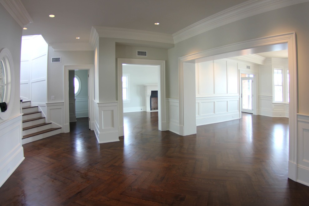 Inspiration for a large traditional foyer in New York with grey walls, dark hardwood floors, a medium wood front door and a double front door.