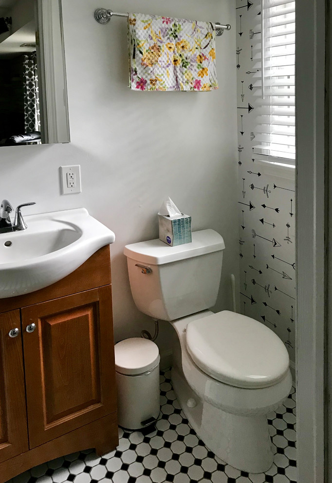 Design ideas for a small eclectic 3/4 bathroom in New York with raised-panel cabinets, medium wood cabinets, a two-piece toilet, white tile, subway tile, white walls, ceramic floors, a console sink, white floor, a hinged shower door, an alcove shower, solid surface benchtops and white benchtops.
