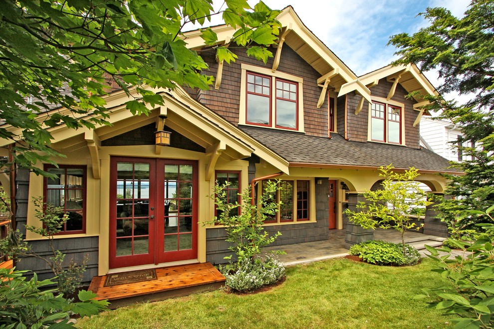 Photo of an arts and crafts two-storey exterior in Seattle with wood siding.