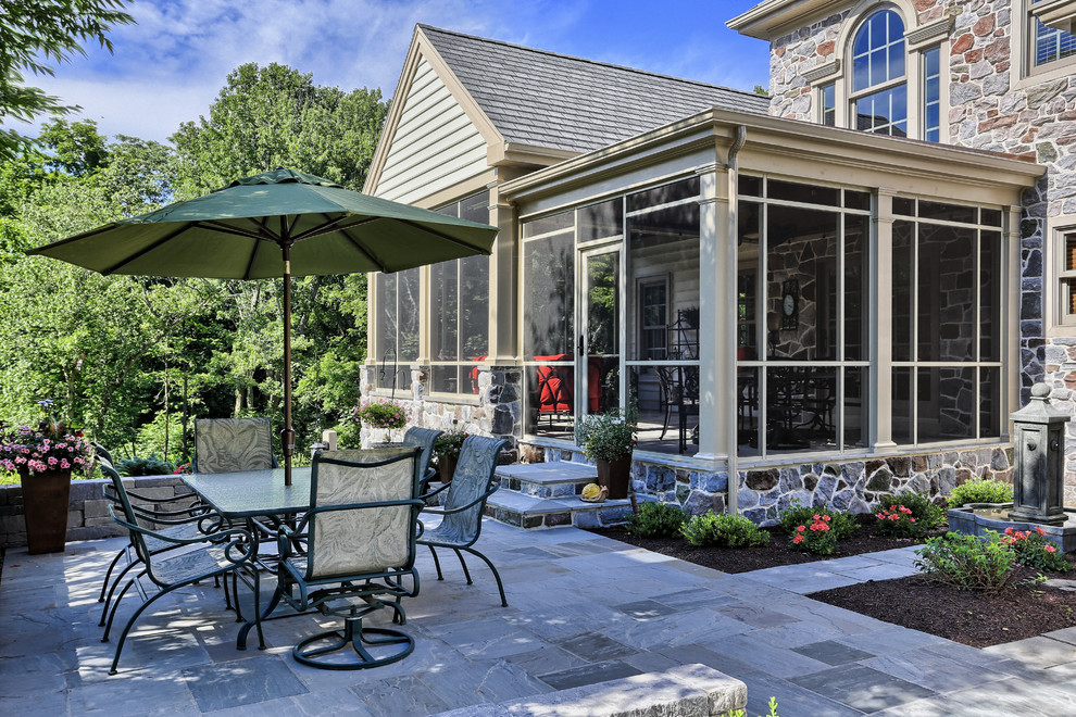 Inspiration for a large backyard patio remodel with a roof extension