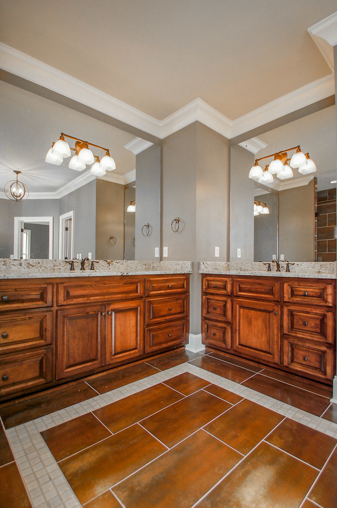 Modern master bathroom in Nashville with an undermount sink, raised-panel cabinets, dark wood cabinets, granite benchtops, a drop-in tub, an alcove shower, porcelain tile, grey walls, mosaic tile floors and brown tile.