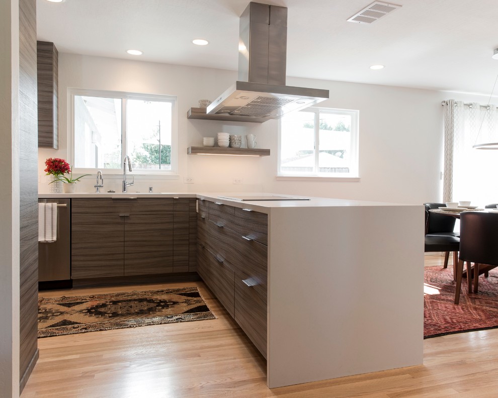 This is an example of a modern eat-in kitchen in San Francisco with an undermount sink, flat-panel cabinets, grey cabinets, quartz benchtops, yellow splashback, stainless steel appliances, light hardwood floors and a peninsula.
