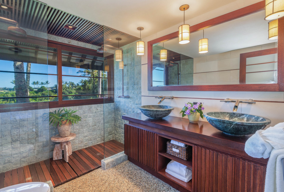 Design ideas for a large tropical bathroom in Hawaii with dark wood cabinets, an alcove shower, gray tile, white walls, a vessel sink, wood benchtops, grey floor, an open shower, brown benchtops, a double vanity and a built-in vanity.