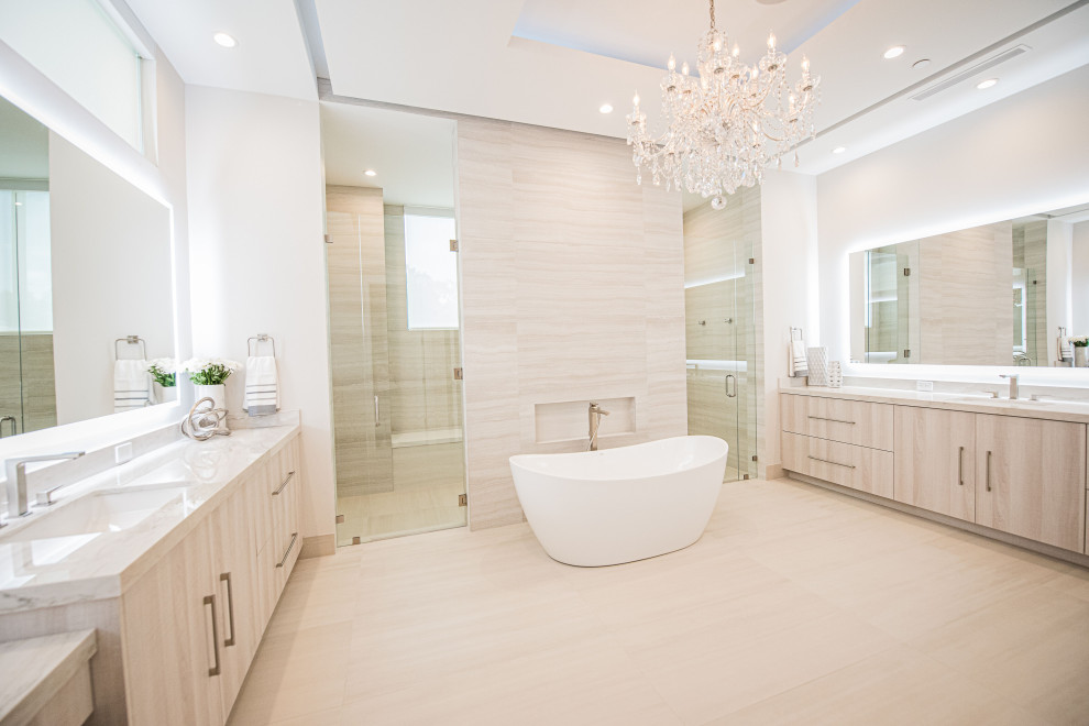 Design ideas for an expansive modern ensuite bathroom in Miami with flat-panel cabinets, light wood cabinets, a freestanding bath, a double shower, a bidet, white tiles, porcelain tiles, white walls, porcelain flooring, a submerged sink, quartz worktops, beige floors, a hinged door, white worktops, an enclosed toilet, double sinks, a built in vanity unit and a drop ceiling.