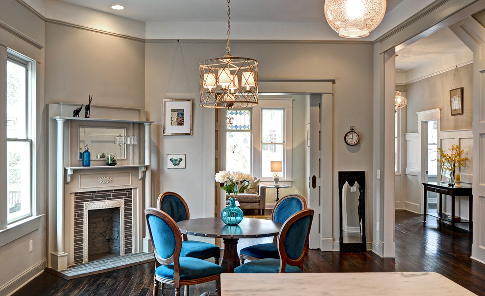 Photo of a mid-sized traditional kitchen/dining combo in Atlanta with grey walls, dark hardwood floors and a corner fireplace.