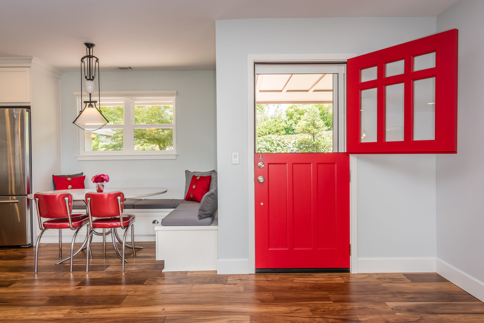 Photo of a mid-sized arts and crafts front door in San Luis Obispo with blue walls, medium hardwood floors, a dutch front door and a red front door.